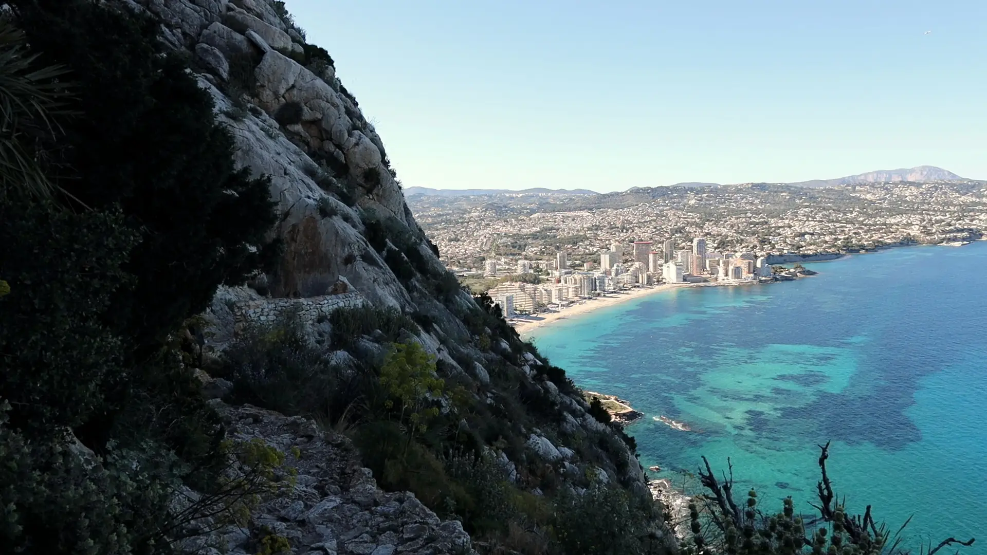 Calpe bay from high on the rock, turquoise water and the town along the beach